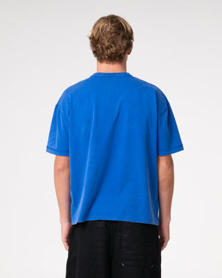 Man wearing Sosa Cropped Tee in Washed Royal Blue