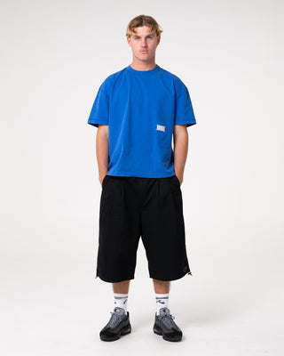 Man wearing Sosa Cropped Tee in Washed Royal Blue