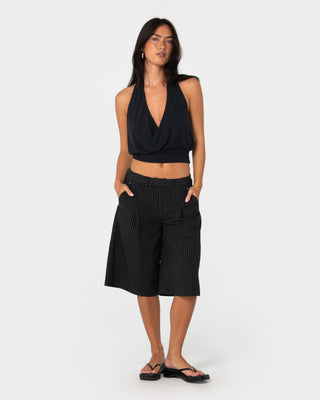 Woman wearing Big Bad Finance Mommy Low Rise Short in Black Pinstripe