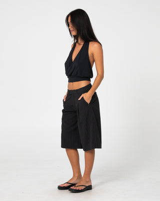 Woman wearing Big Bad Finance Mommy Low Rise Short in Black Pinstripe