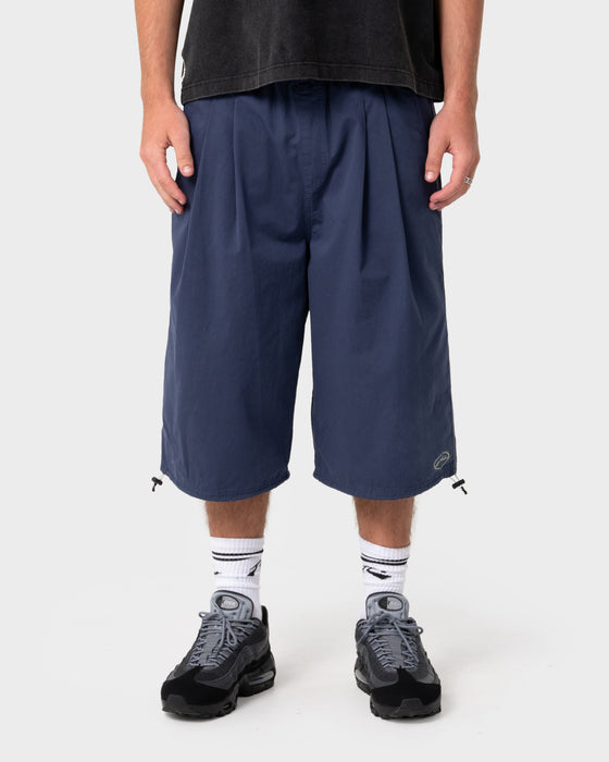 man-wearing-mamba-3-4-baggy-short-in-dark-blue