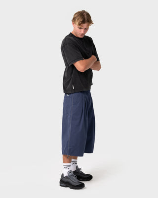 Man wearing Mamba 3/4 Baggy Short in Dark Blue