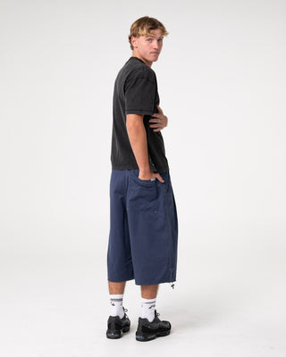 Man wearing Mamba 3/4 Baggy Short in Dark Blue