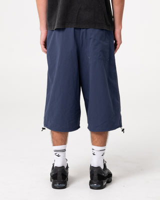 Man wearing Mamba 3/4 Baggy Short in Dark Blue
