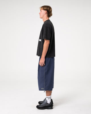 Man wearing Mamba 3/4 Baggy Short in Dark Blue