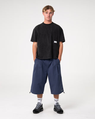 Man wearing Mamba 3/4 Baggy Short in Dark Blue
