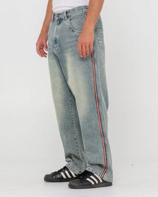 Man wearing Flip Daddy 2.0 Jean - Dirty Dawg in Dirty Dawg / Orange