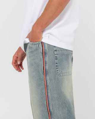 Man wearing Flip Daddy 2.0 Jean - Dirty Dawg in Dirty Dawg / Orange