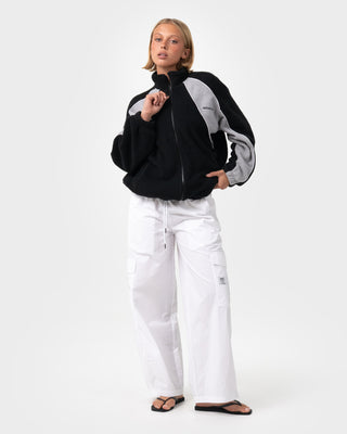 Woman wearing Two Tides Zip Through Sherpa Fleece in Black - Coming Soon