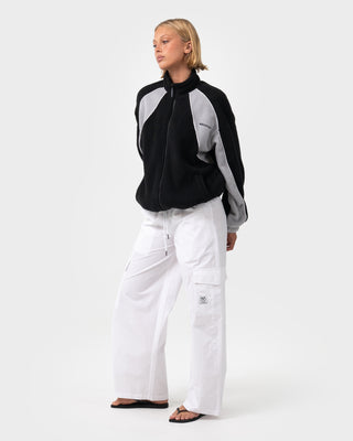 Woman wearing Two Tides Zip Through Sherpa Fleece in Black - Coming Soon