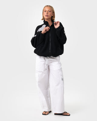 Woman wearing Two Tides Zip Through Sherpa Fleece in Black - Coming Soon