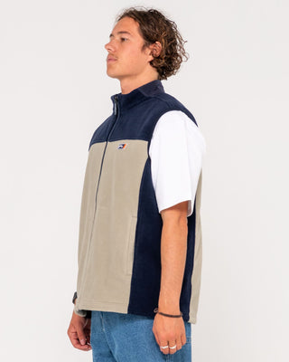 Man wearing On The Run Tech Fleece Vest in Abbey Stone