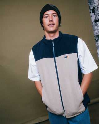 Man wearing On The Run Tech Fleece Vest in Abbey Stone