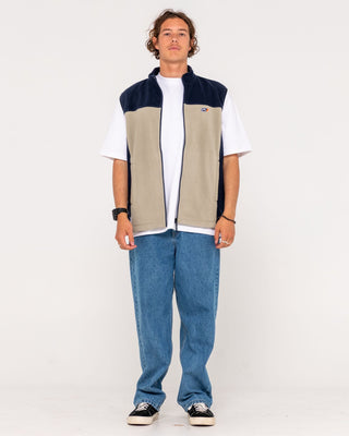 Man wearing On The Run Tech Fleece Vest in Abbey Stone