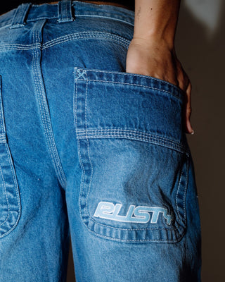 Woman wearing Flip Mommy Low Rise Wide Leg Denim Jean in Blasted Middy Blue / Blue