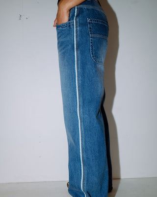 Woman wearing Flip Mommy Low Rise Wide Leg Denim Jean in Blasted Middy Blue / Blue