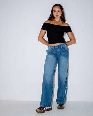 Woman wearing Flip Mommy Low Rise Wide Leg Denim Jean in Blasted Middy Blue / Blue