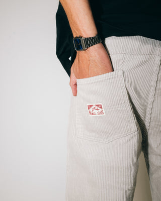 Man wearing Rifts Straight Leg Cord Pant in Oyster Grey