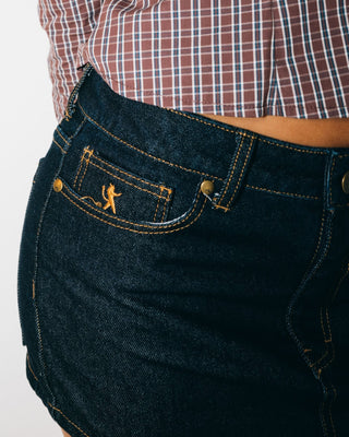 Woman wearing Risque Low Rise Denim Micro Skirt in Raw Dawg