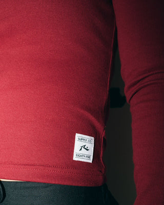 Woman wearing Rusty Essentials Ribbed Long Sleeve Tee in Rhubarb