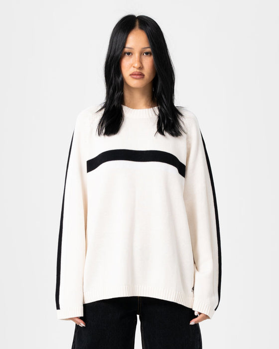 woman-wearing-white-lines-long-sleeve-crew-neck-knit-in-cream-black
