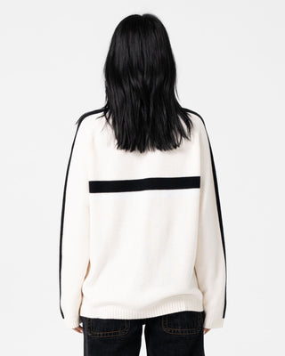 Woman wearing White Lines Long Sleeve Crew Neck Knit in Cream / Black