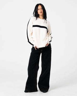 Woman wearing White Lines Long Sleeve Crew Neck Knit in Cream / Black