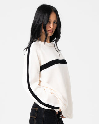 Woman wearing White Lines Long Sleeve Crew Neck Knit in Cream / Black