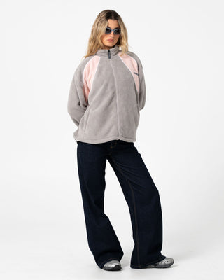 Woman wearing Two Tides Zip Through Sherpa Fleece in Pink A Boo / Grey