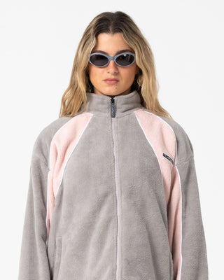 Woman wearing Two Tides Zip Through Sherpa Fleece in Pink A Boo / Grey