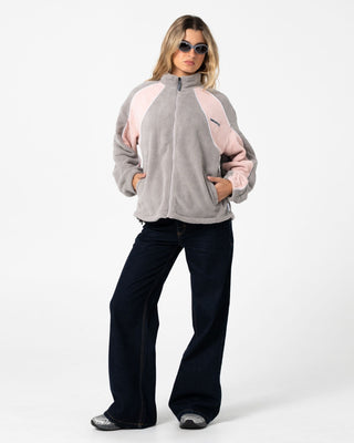 Woman wearing Two Tides Zip Through Sherpa Fleece in Pink A Boo / Grey