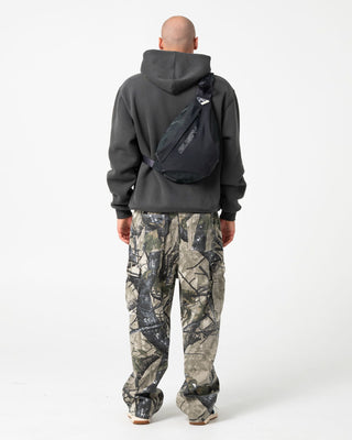 Man wearing Outliner Hooded Fleece in Carbon