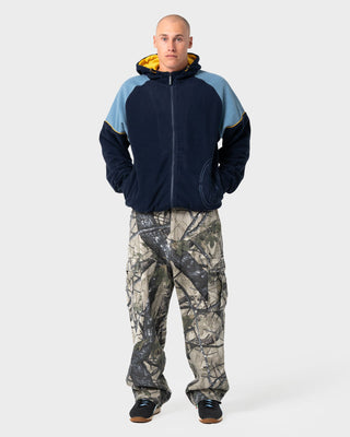 Man wearing Tectonic Hooded Zip Thru Polar Fleece in Navy Blue