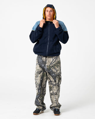 Man wearing Tectonic Hooded Zip Thru Polar Fleece in Navy Blue