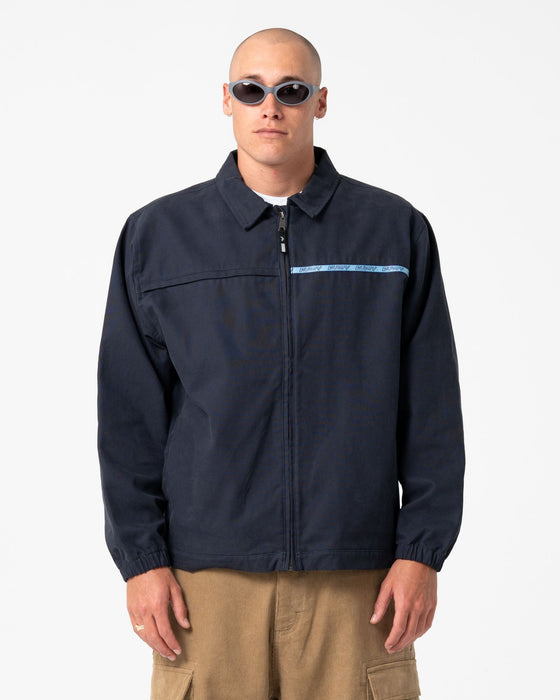 man-wearing-ushka-shell-jacket-in-navy-blue