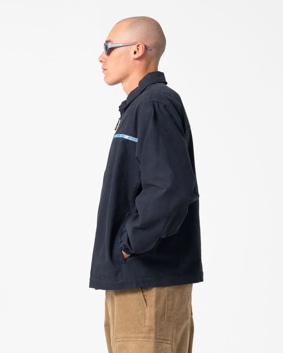 man-wearing-ushka-shell-jacket-in-navy-blue