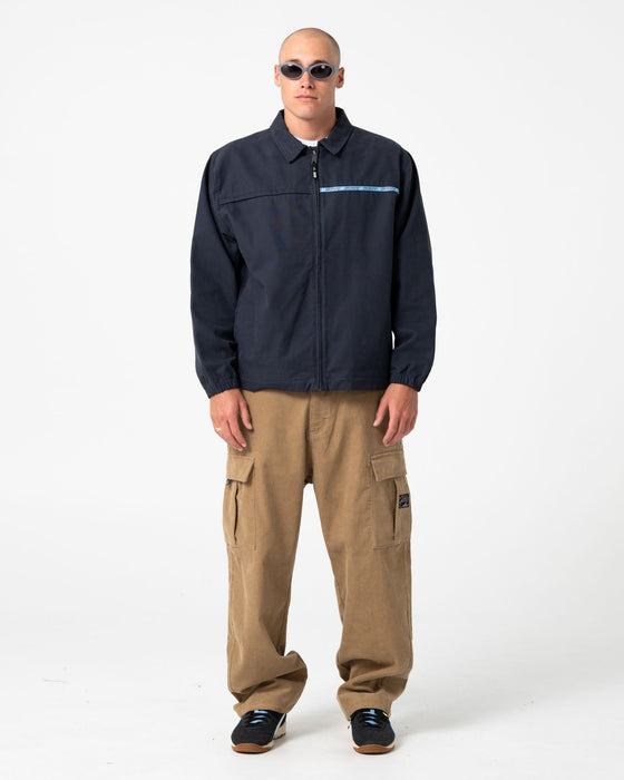 man-wearing-ushka-shell-jacket-in-navy-blue