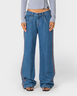 Woman wearing Flip Mommy Low Rise Wide Leg Denim Jean in Middy Blue / Orange