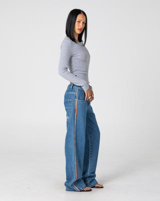 Woman wearing Flip Mommy Low Rise Wide Leg Denim Jean in Middy Blue / Orange