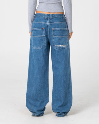 Woman wearing Flip Mommy Low Rise Wide Leg Denim Jean in Middy Blue / Orange