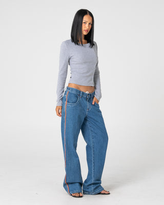 Woman wearing Flip Mommy Low Rise Wide Leg Denim Jean in Middy Blue / Orange