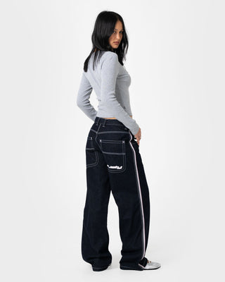 Woman wearing Flip Mommy Low Rise Wide Leg Denim Jean in Raw Dawg / Pink
