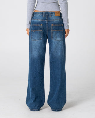 Woman wearing Lucy Loose Low Rise Jean in Blasted Deep Sea Blue