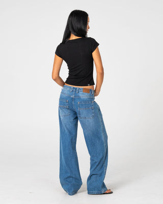 Woman wearing Wendy Wide Low Rise Denim Jean in Blasted Middy Blue