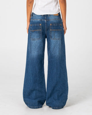 Woman wearing Wendy Wide Low Rise Denim Jean in Blasted Deep Sea Blue