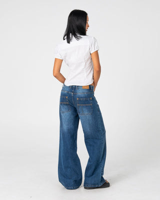 Woman wearing Wendy Wide Low Rise Denim Jean in Blasted Deep Sea Blue