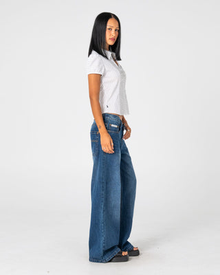 Woman wearing Wendy Wide Low Rise Denim Jean in Blasted Deep Sea Blue