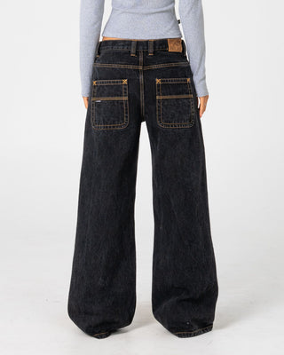 Woman wearing Wendy Wide Low Rise Denim Jean in Black Out