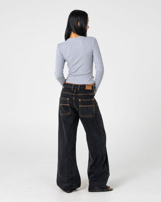 Woman wearing Wendy Wide Low Rise Denim Jean in Black Out