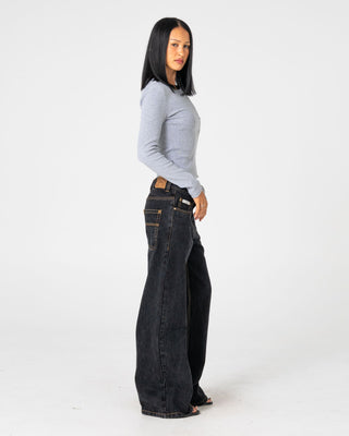 Woman wearing Wendy Wide Low Rise Denim Jean in Black Out